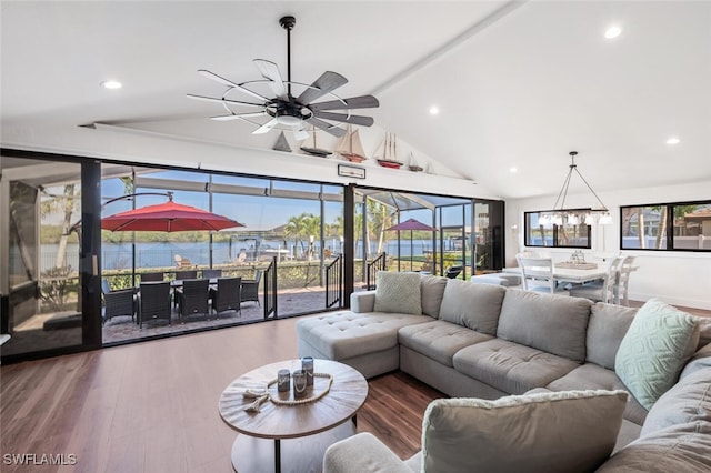 living area with lofted ceiling, wood finished floors, recessed lighting, and ceiling fan with notable chandelier