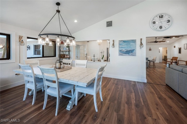 dining area with baseboards, visible vents, wood finished floors, high vaulted ceiling, and ceiling fan with notable chandelier