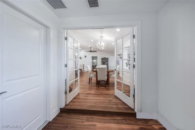 entryway with dark wood-style flooring, visible vents, a notable chandelier, and french doors