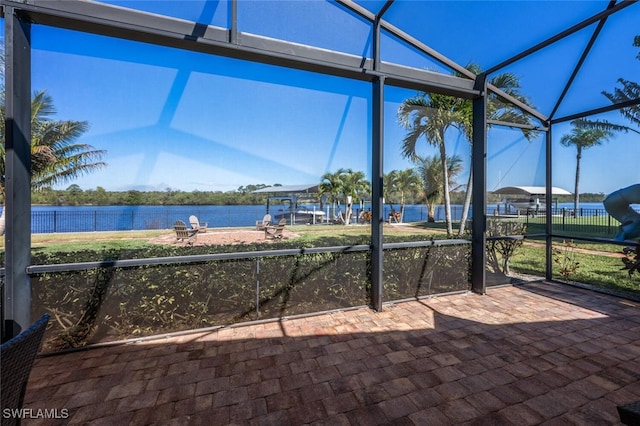 unfurnished sunroom with a water view