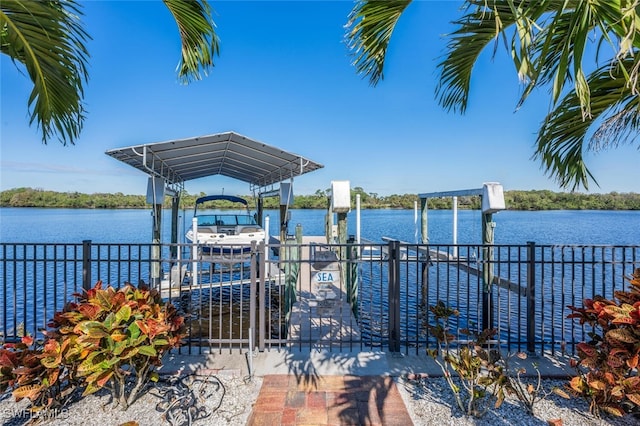 dock area with a water view and boat lift