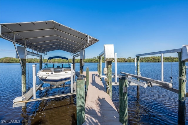 dock area featuring a water view and boat lift