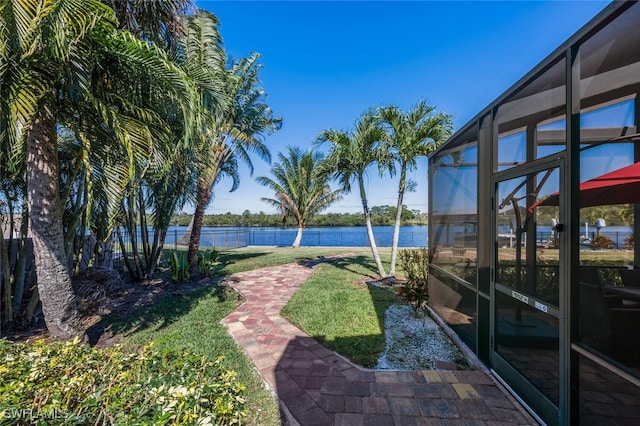 view of yard featuring a water view and fence