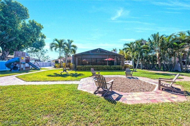 surrounding community featuring playground community, a yard, and fence