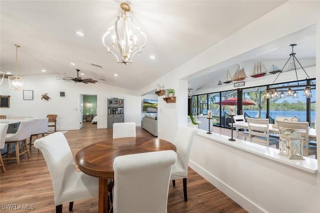 dining space with vaulted ceiling, wood finished floors, and baseboards