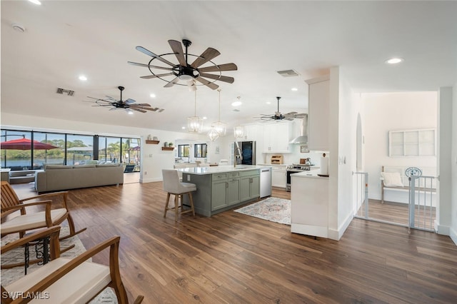 kitchen with visible vents, appliances with stainless steel finishes, open floor plan, dark wood-type flooring, and light countertops