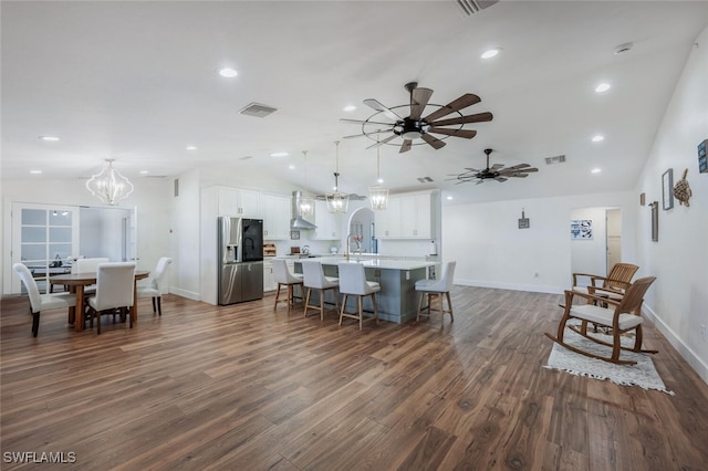 dining area with dark wood-style floors, lofted ceiling, visible vents, and recessed lighting