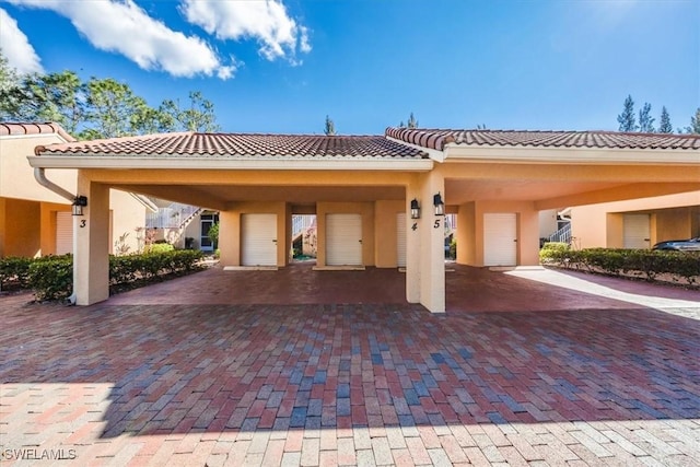 exterior space with a tile roof and stucco siding