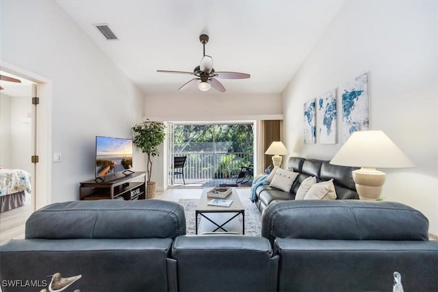 living room featuring a ceiling fan, visible vents, and wood finished floors