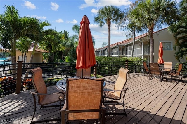 wooden terrace featuring outdoor dining area