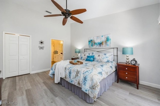 bedroom featuring a closet, visible vents, baseboards, and wood finished floors