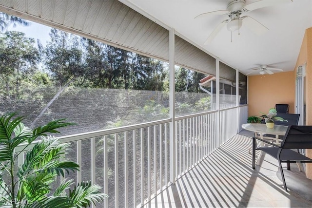 sunroom featuring ceiling fan