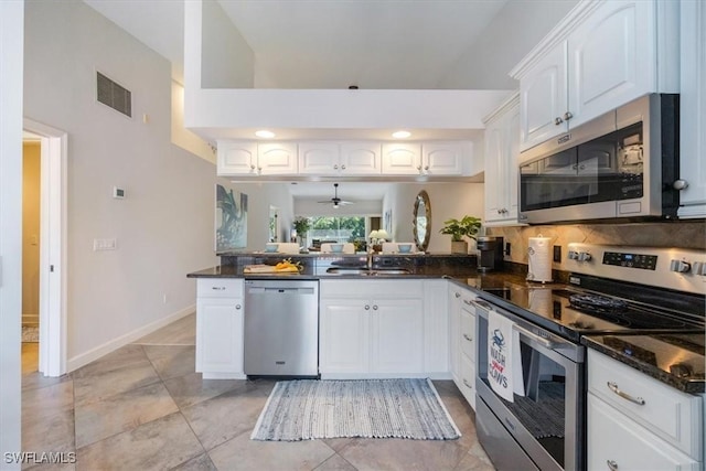 kitchen with a sink, visible vents, baseboards, white cabinetry, and appliances with stainless steel finishes