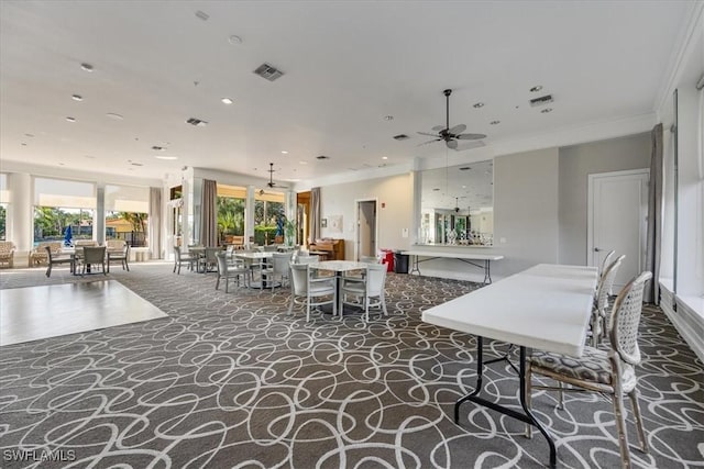 carpeted dining area featuring a ceiling fan, visible vents, crown molding, and recessed lighting