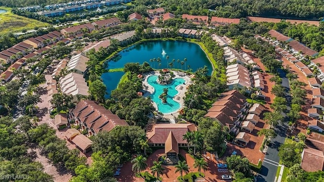 drone / aerial view featuring a residential view and a water view