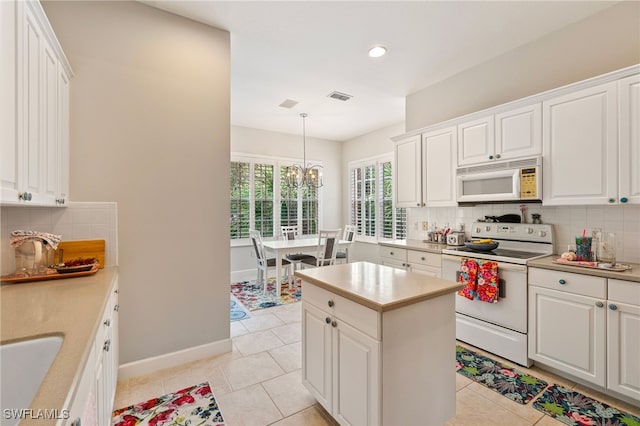 kitchen featuring white appliances, light tile patterned flooring, visible vents, and backsplash