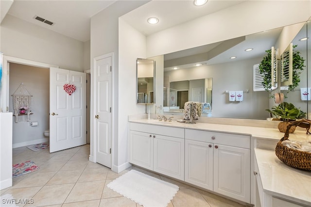 bathroom with visible vents, toilet, vanity, and tile patterned flooring