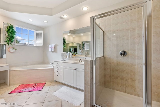 bathroom featuring tile patterned flooring, visible vents, a shower stall, a garden tub, and vanity