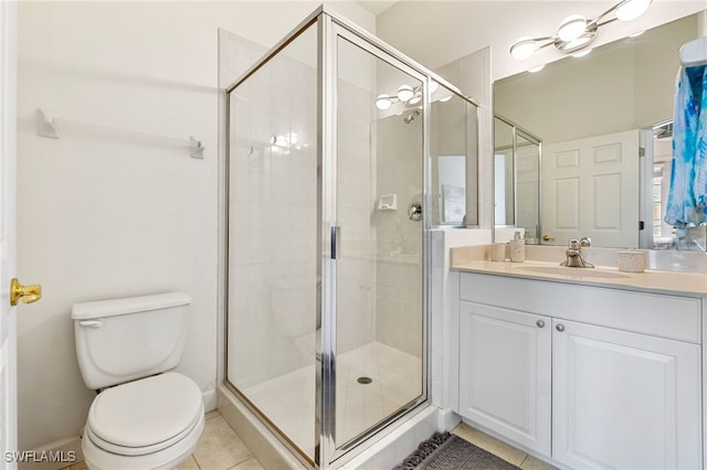 full bath with vanity, baseboards, a stall shower, tile patterned floors, and toilet