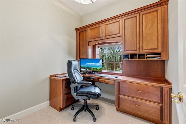 office space with light tile patterned flooring and baseboards