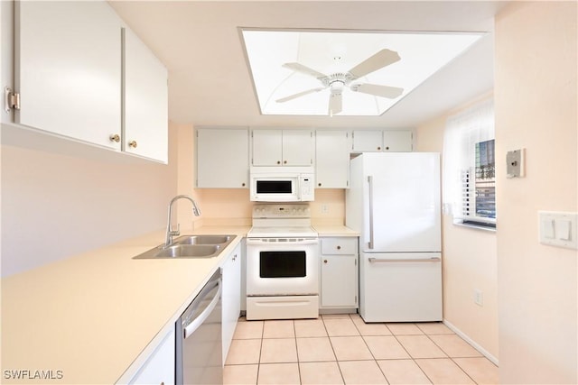 kitchen with light countertops, white cabinets, ceiling fan, a sink, and white appliances