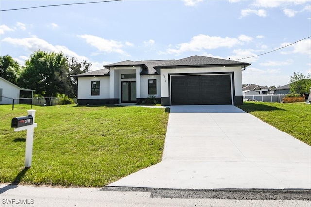 prairie-style home with a front lawn, fence, and stucco siding