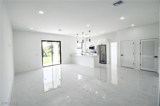 unfurnished living room with recessed lighting, marble finish floor, visible vents, and a sink