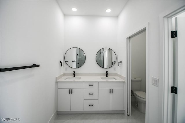 full bathroom with recessed lighting, a sink, toilet, and double vanity