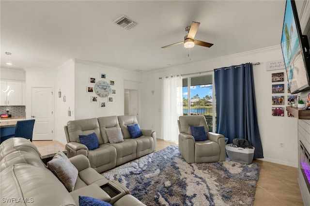 living room with visible vents, ornamental molding, light tile patterned flooring, ceiling fan, and baseboards