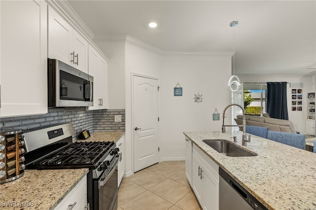 kitchen with appliances with stainless steel finishes, white cabinetry, and a sink