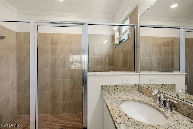 full bath featuring a stall shower, vanity, and crown molding