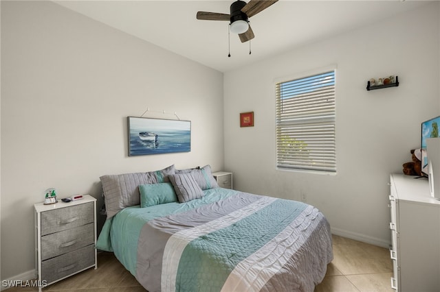 bedroom featuring light tile patterned floors, ceiling fan, and baseboards