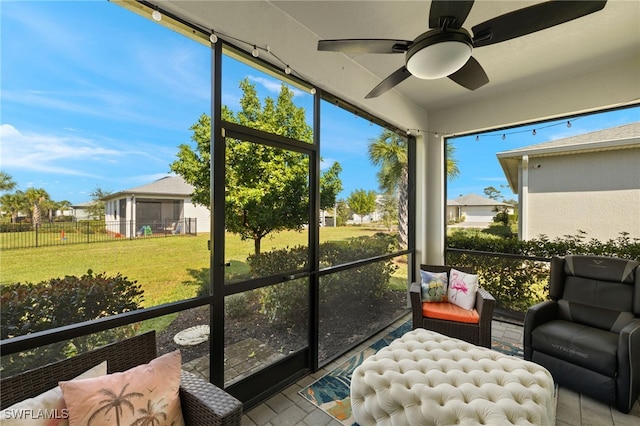 sunroom / solarium with a ceiling fan and plenty of natural light