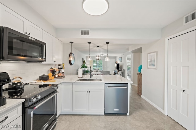 kitchen featuring visible vents, white cabinets, appliances with stainless steel finishes, a peninsula, and a sink