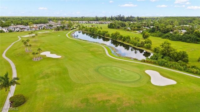 drone / aerial view featuring view of golf course and a water view