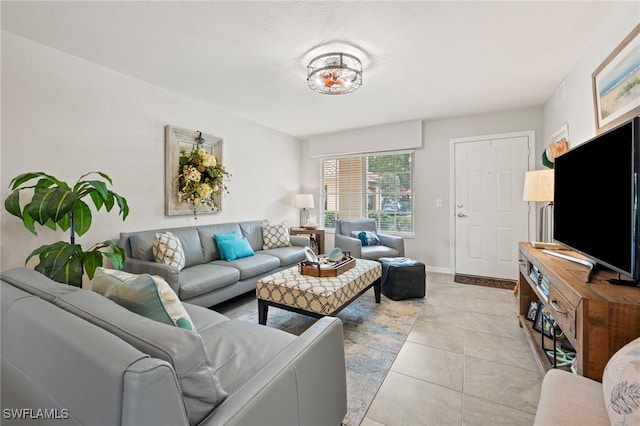 living area featuring light tile patterned floors and baseboards