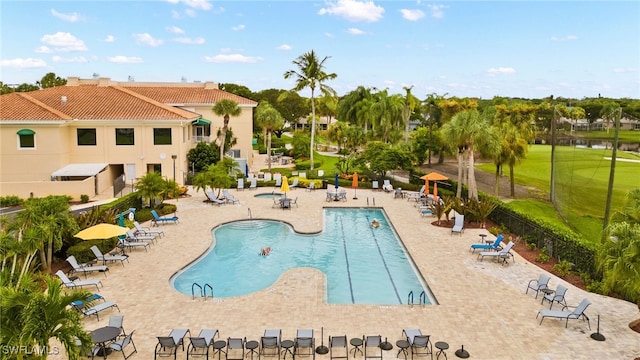 community pool featuring a patio area and fence