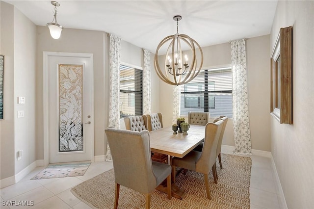 dining space with a chandelier, light tile patterned flooring, baseboards, and a healthy amount of sunlight