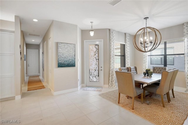 dining space featuring baseboards, light tile patterned floors, visible vents, and a notable chandelier