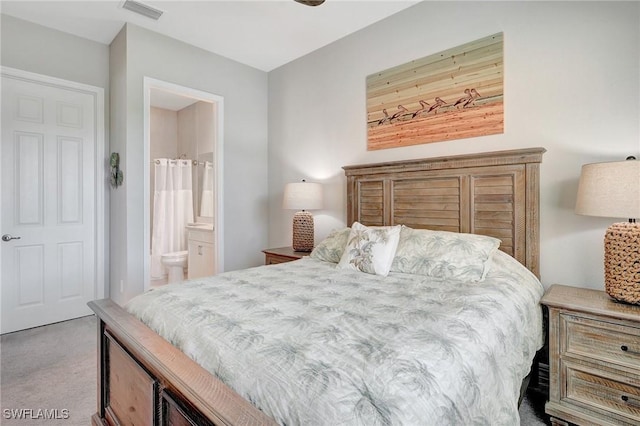 bedroom with carpet, ensuite bath, and visible vents