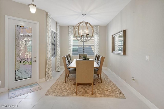 tiled dining room with baseboards and a notable chandelier