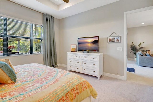 bedroom with light carpet, baseboards, and light tile patterned flooring