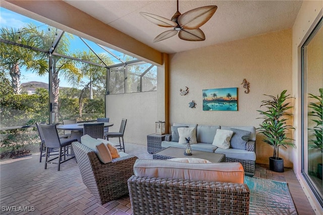 view of patio with outdoor dining area, a lanai, an outdoor living space, and a ceiling fan