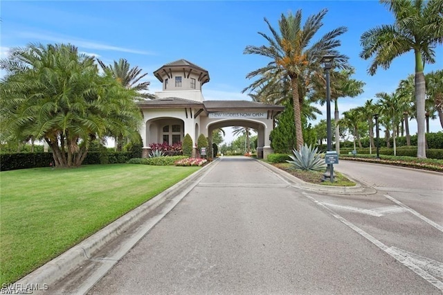 view of community with a yard and driveway