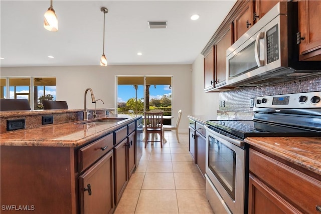 kitchen with stainless steel appliances, hanging light fixtures, a sink, and visible vents