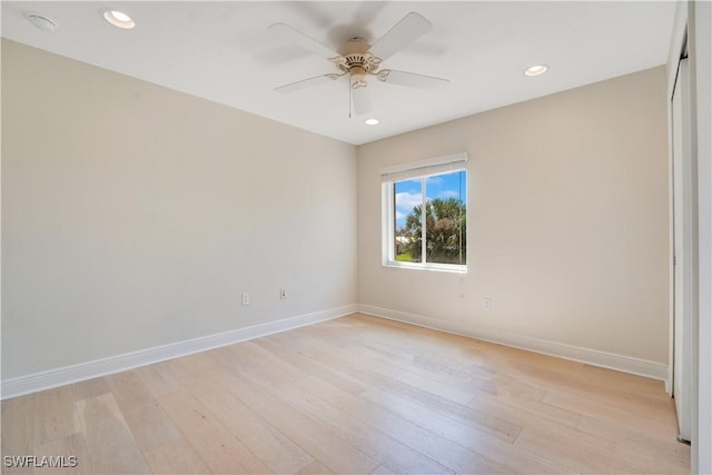 spare room with recessed lighting, light wood-style flooring, and baseboards