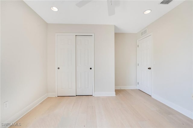 unfurnished bedroom featuring visible vents, light wood-style flooring, and baseboards