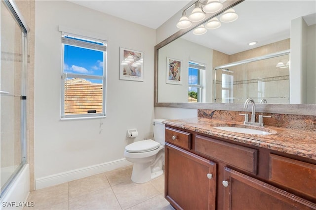 full bath featuring plenty of natural light, vanity, toilet, and tile patterned floors