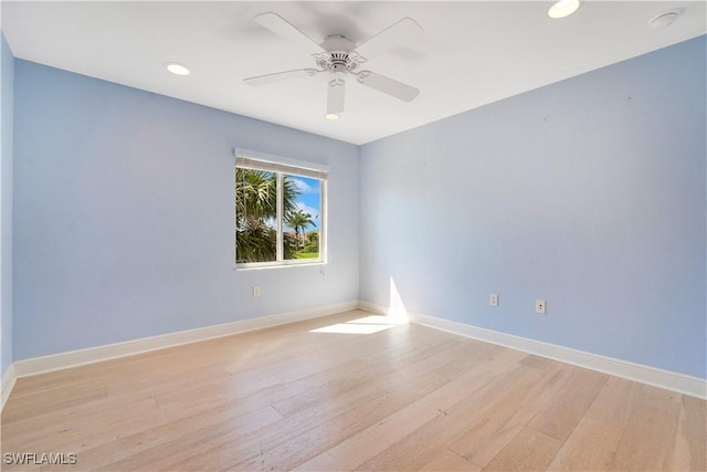 spare room with ceiling fan, light wood finished floors, recessed lighting, and baseboards