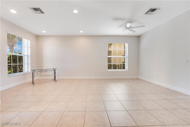 unfurnished room with a ceiling fan, recessed lighting, visible vents, and baseboards